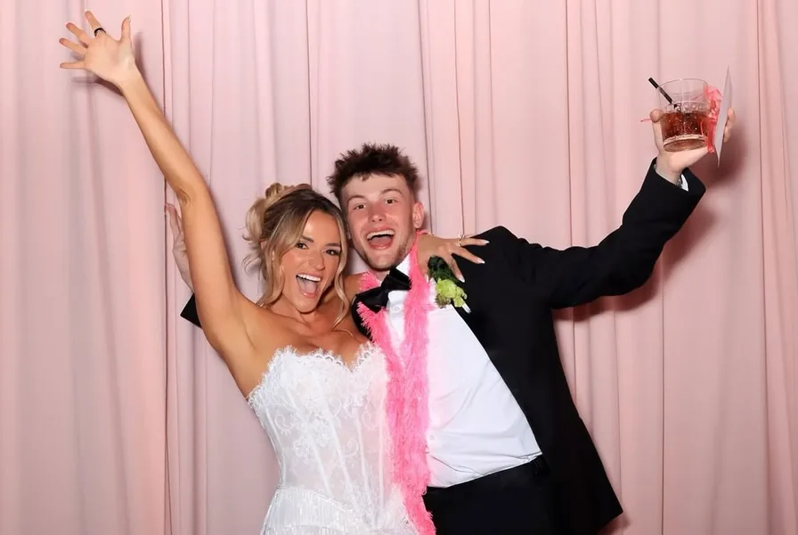 Chase in a tux at a wedding photobooth